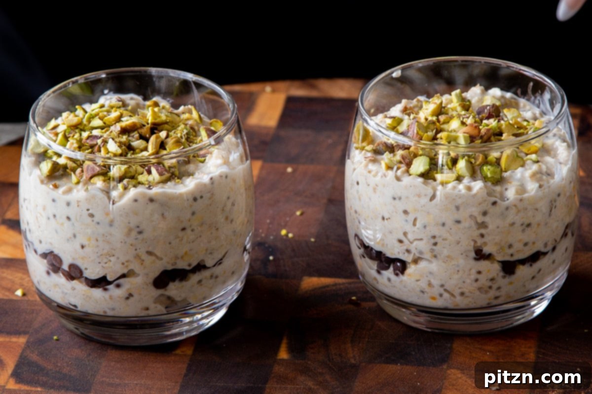 Easy Cannoli Overnight Oats: 30-Minute, Gluten-Free & Soy-Free 16 Chopped pistachios being sprinkled generously over the top of the cannoli oat mixture in a glass cup.