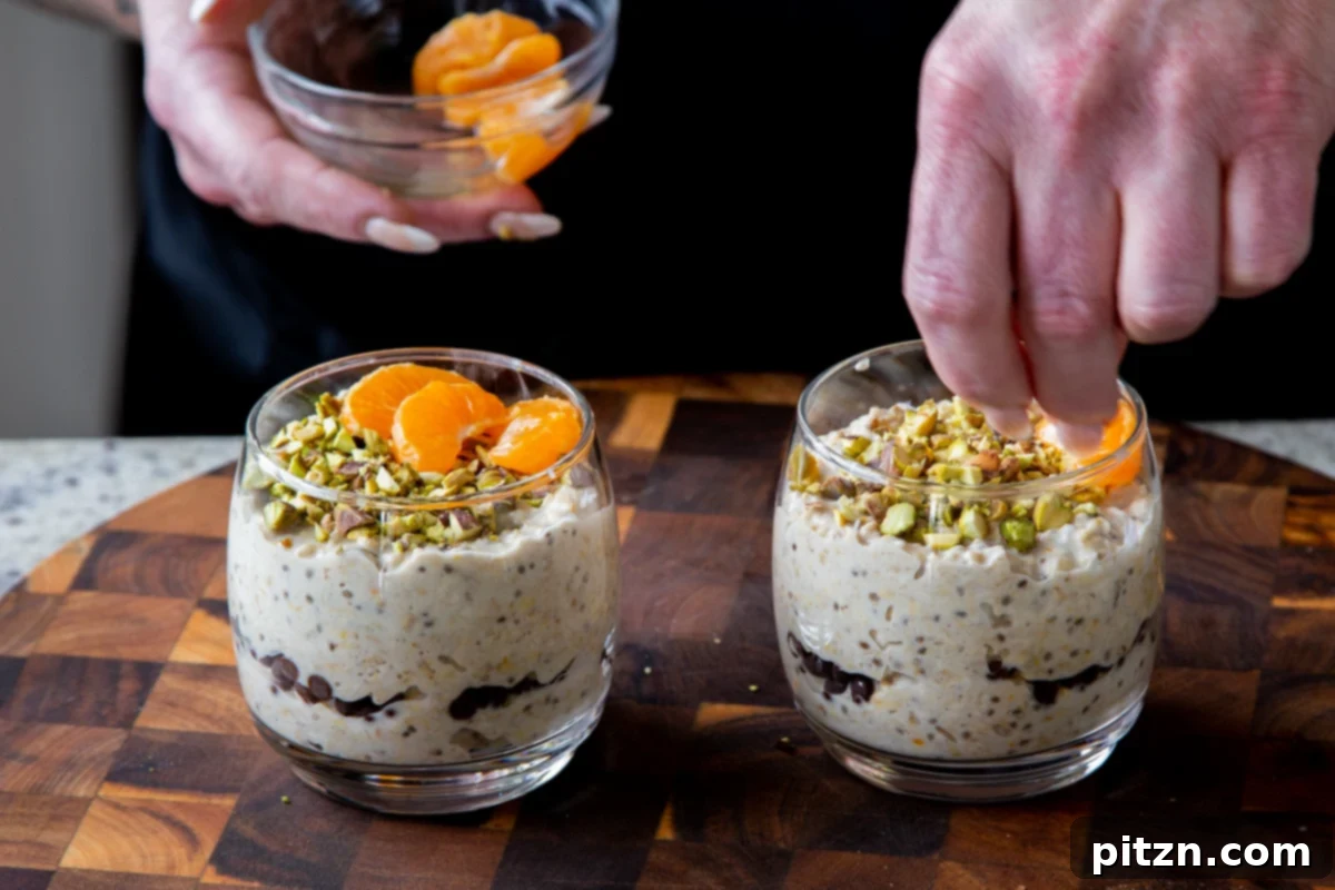 Easy Cannoli Overnight Oats: 30-Minute, Gluten-Free & Soy-Free 17 The cannoli oats mixture topped with both chopped pistachios and fresh orange slices in a glass cup.