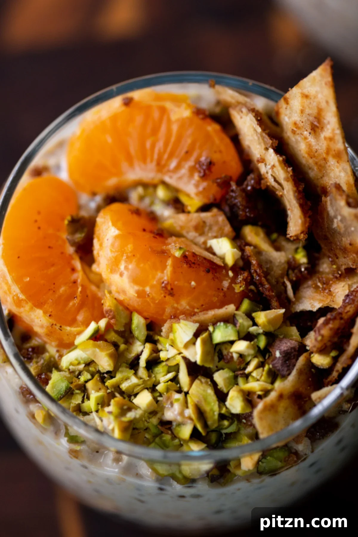 Easy Cannoli Overnight Oats: 30-Minute, Gluten-Free & Soy-Free 4 A detailed close-up of the vibrant topping on Cannoli Overnight Oats, featuring bright orange slices, green pistachios, and golden crispy cinnamon sugar tortilla pieces.