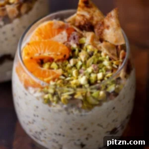 Cannoli Overnight Oats in a glass, topped with oranges, pistachios, and crispy cinnamon sugar tortilla pieces.