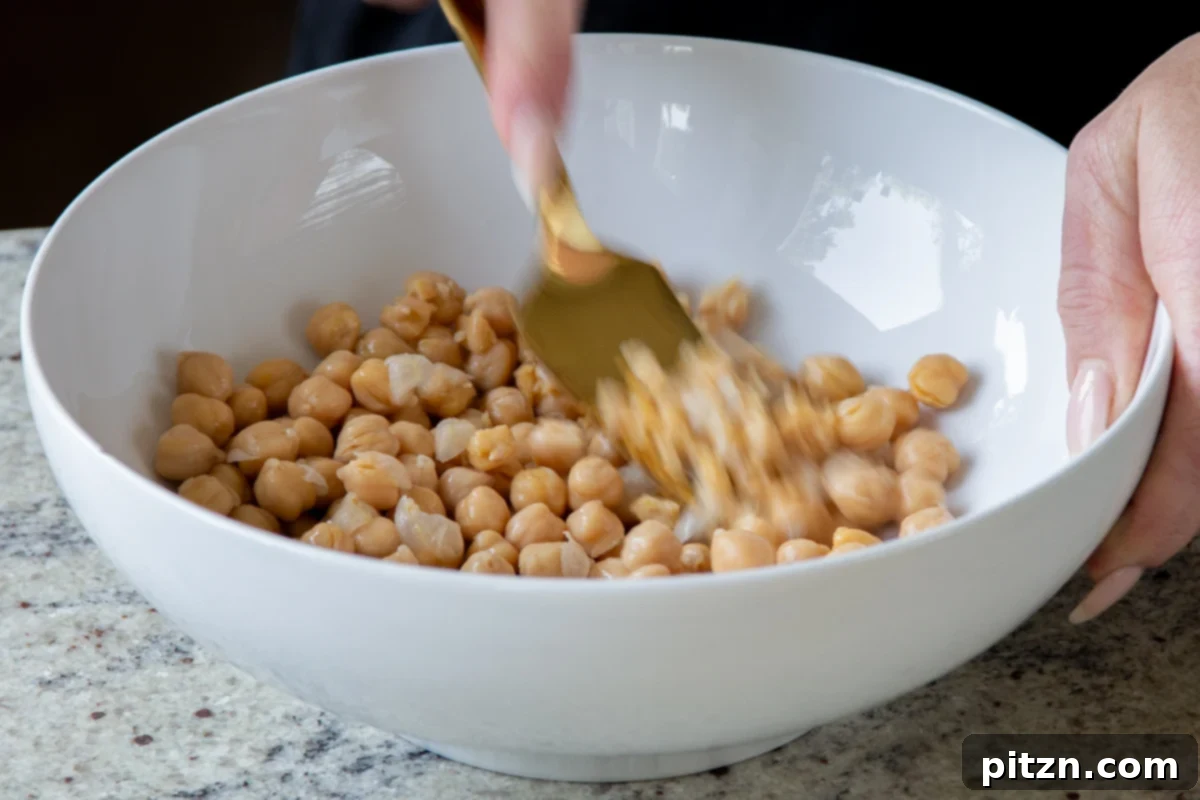 mashing the chickpeas in a large bowl