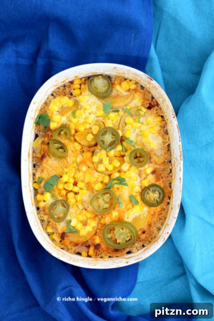 Baked Vegan Quinoa Black Bean Casserole topped with corn and cheddar cream sauce