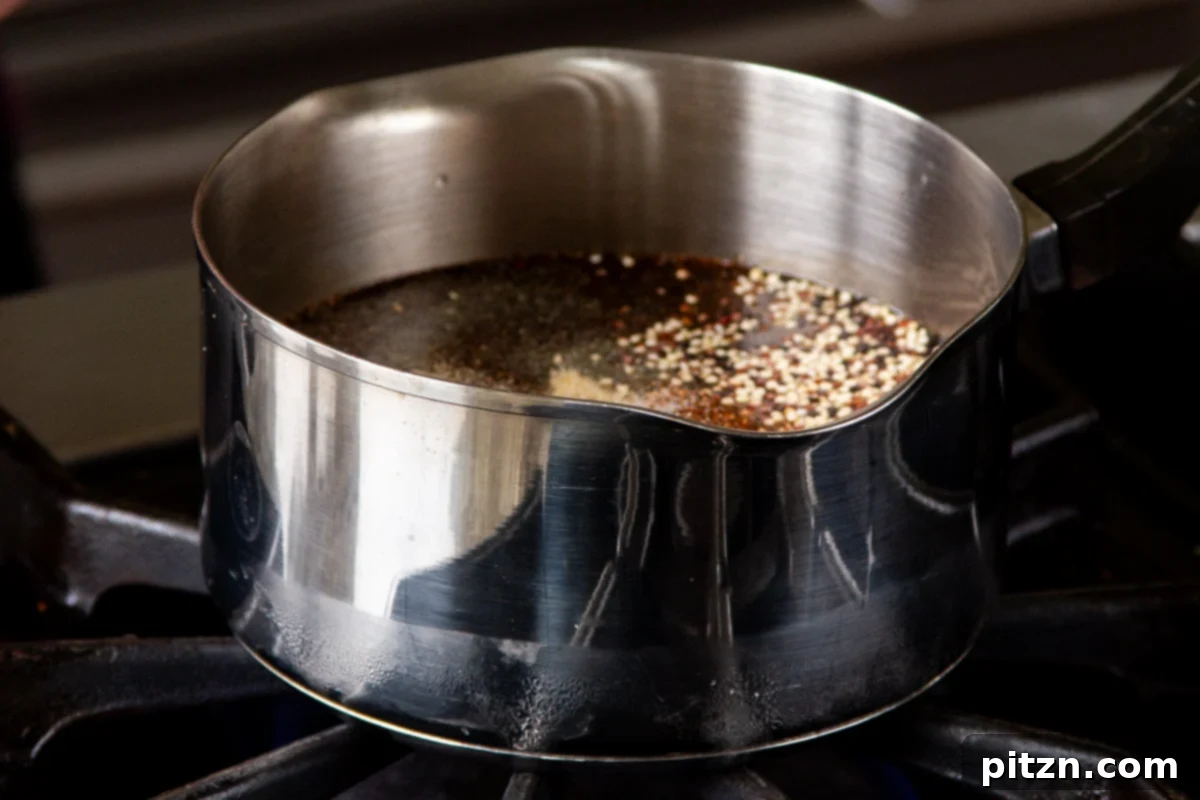 Crispy Quinoa Tacos: Effortlessly Allergy-Friendly 8 Cooking quinoa on the stovetop in a saucepan with a lid partially open