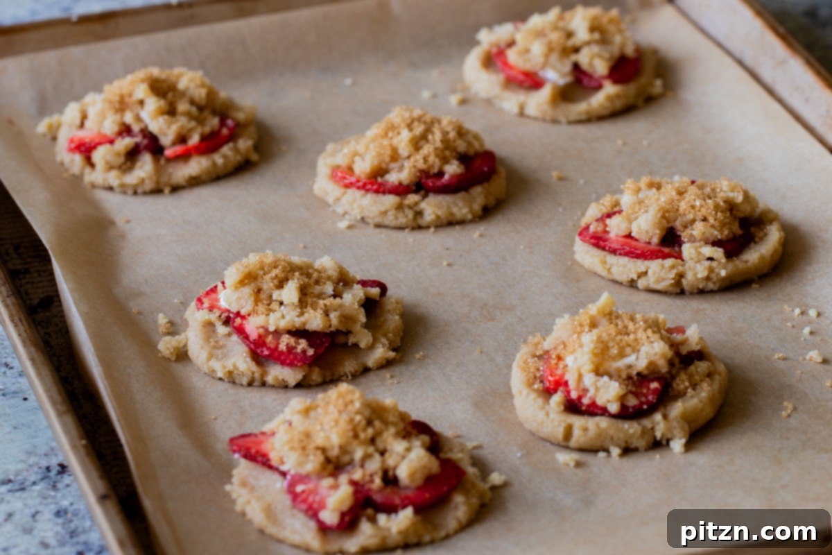 Blissful Strawberry Cheesecake Cookies Without Gluten Soy Or Grains 14 Baked strawberry cheesecake cookies cooling on a baking sheet, showing golden tops and edges