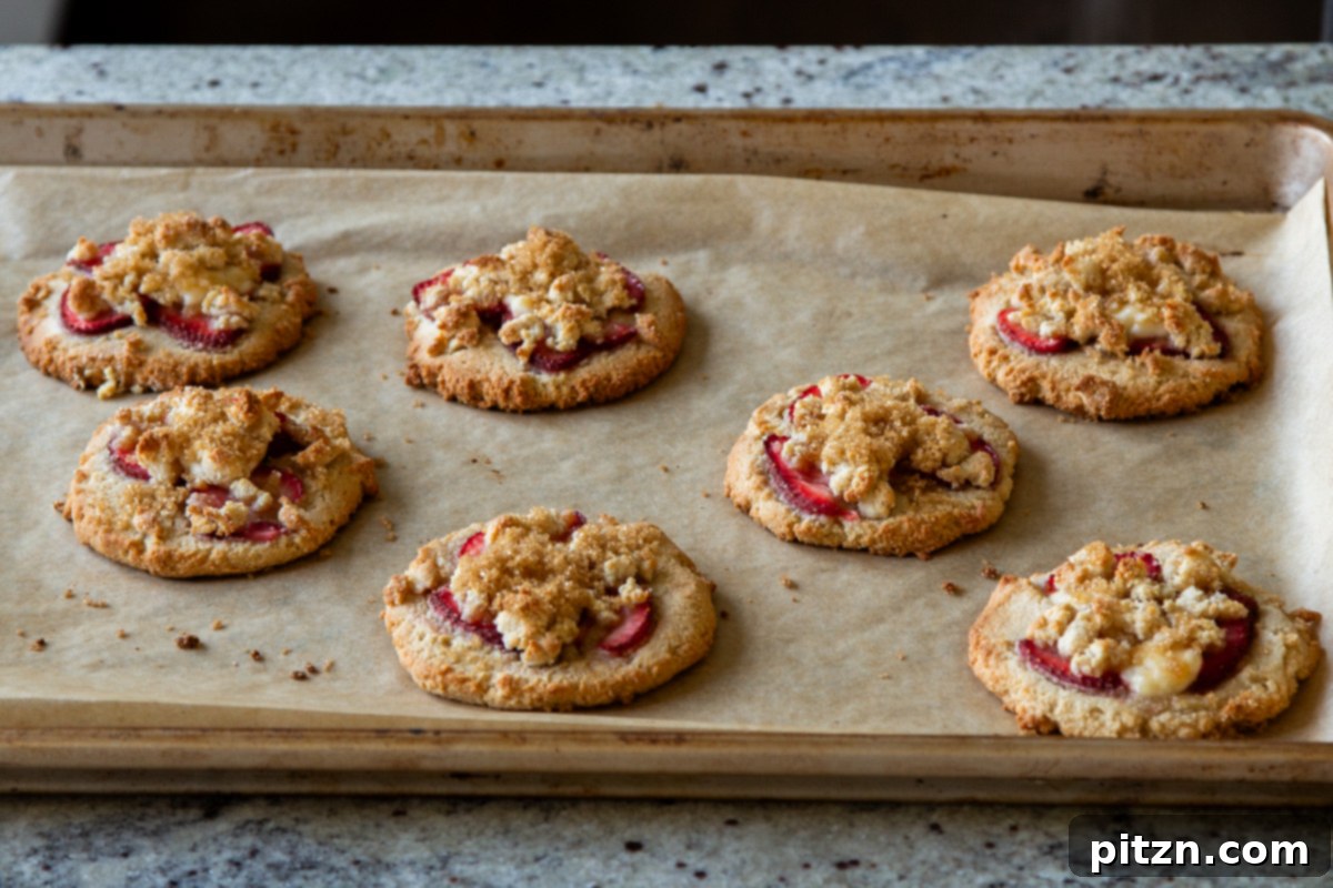 Blissful Strawberry Cheesecake Cookies Without Gluten Soy Or Grains 15 Freshly baked strawberry cheesecake cookies still on the baking sheet, glistening and ready to cool