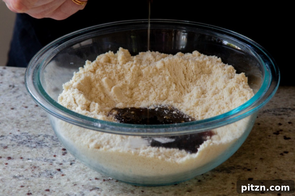 Blissful Strawberry Cheesecake Cookies Without Gluten Soy Or Grains 8 Wet ingredients being added to the dry cookie ingredients in a mixing bowl
