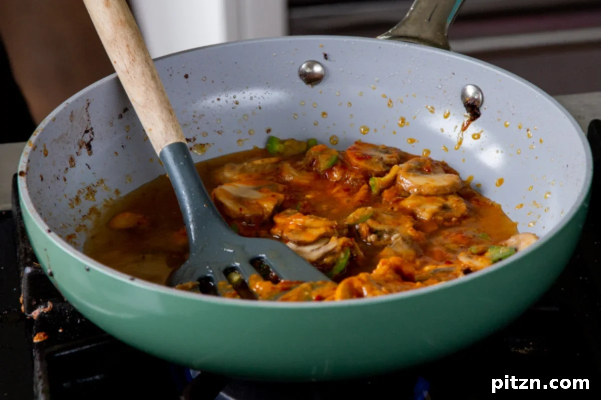 Miso paste being thoroughly dissolved into a small amount of broth with the mushroom mixture, a key step for a smooth, umami-rich ramen broth.