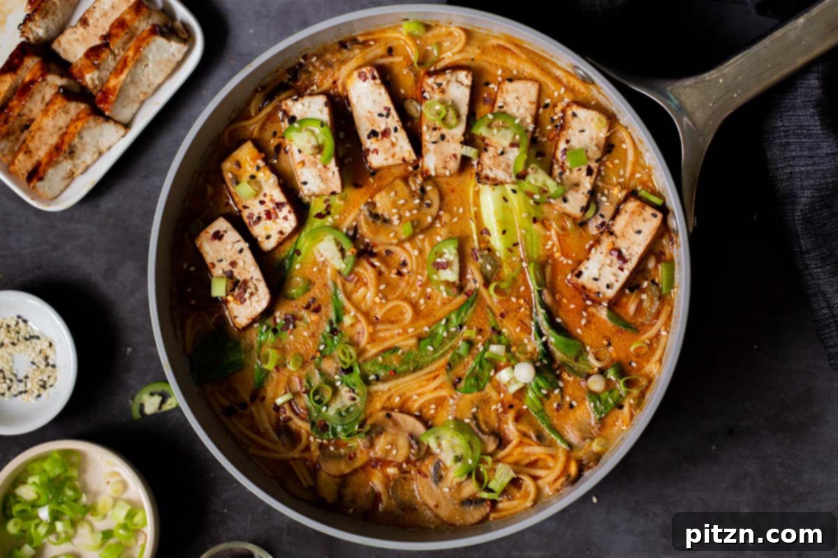 Close-up of the finished vegan Tonkotsu ramen simmering in the pot, beautifully garnished with tofu and fresh toppings, ready to be served and enjoyed.