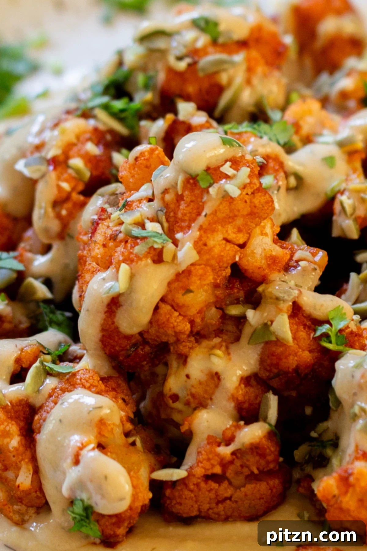 Spicy Harissa Roasted Cauliflower with Creamy Tahini Dill 4 close-up of harissa cauliflower, so you can see the texture and vibrant spices.