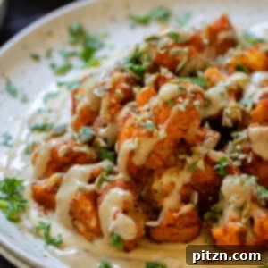 Spicy Harissa Roasted Cauliflower with Creamy Tahini Dill 6 harissa cauliflower wrap tahini sauce on a bed of hummus