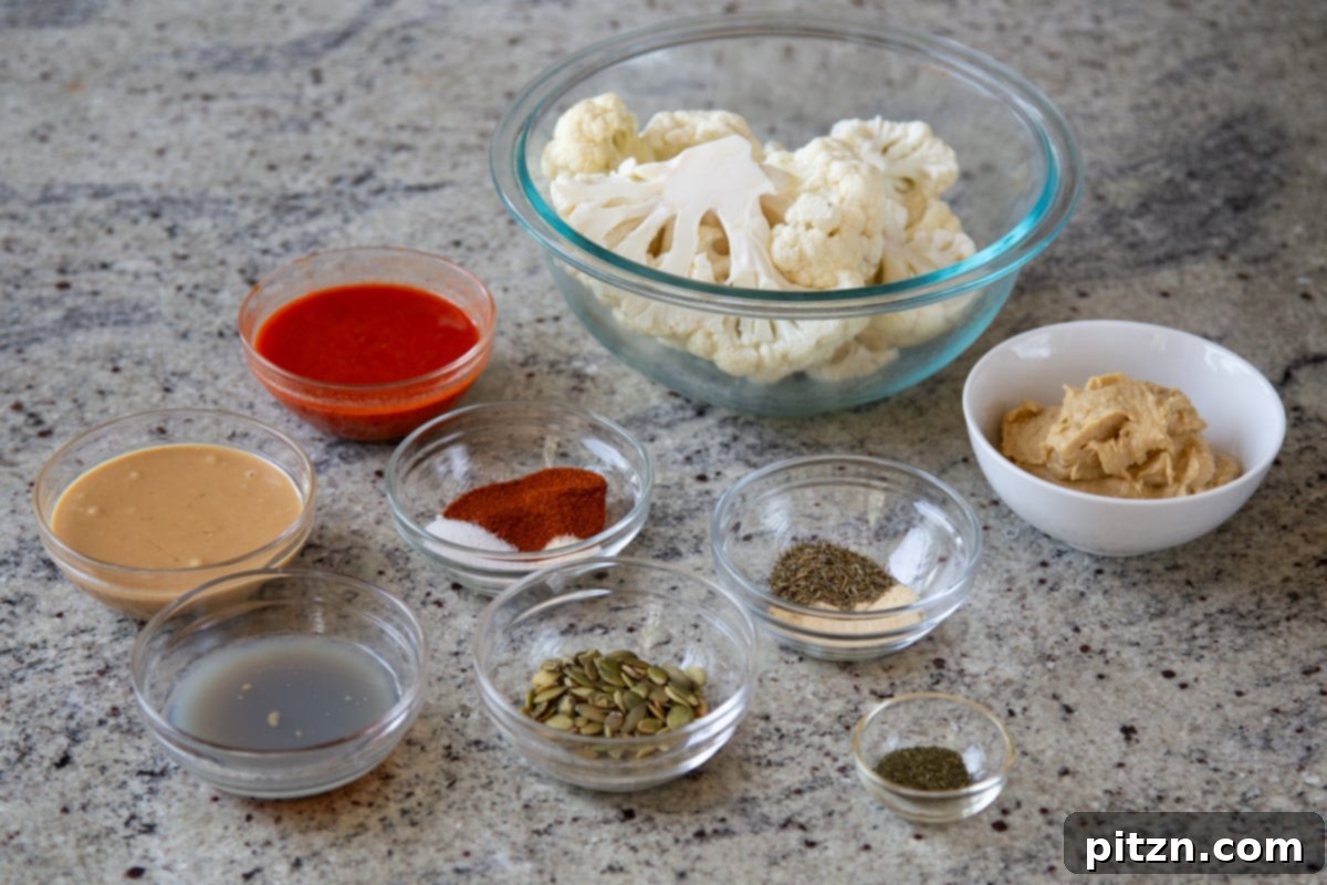 Spicy Harissa Roasted Cauliflower with Creamy Tahini Dill 7 cauliflower, harissa paste, and other ingredients in bowls on a kitchen counter, ready for preparation