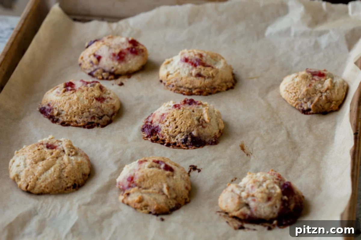 Easy One-Bowl 30-Minute Gluten-Free PB and J Cookies 13 Freshly baked PB&J cookies on the baking sheet, cooled and ready to be transferred.