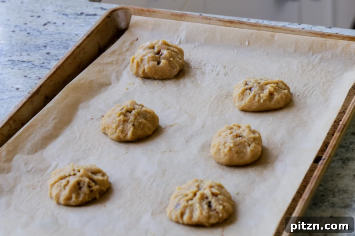 A tray of assembled Tiramisu Cookies, neatly folded and ready to be baked, showcasing their prepared state.