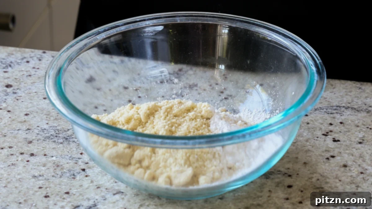 Almond flour and other dry ingredients for Tiramisu Cookies in a mixing bowl, prior to being combined.