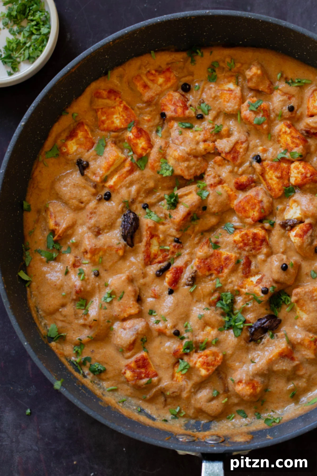 Close-up of a panful of authentic Pahadi Tofu Curry, showcasing its rich texture and spices.