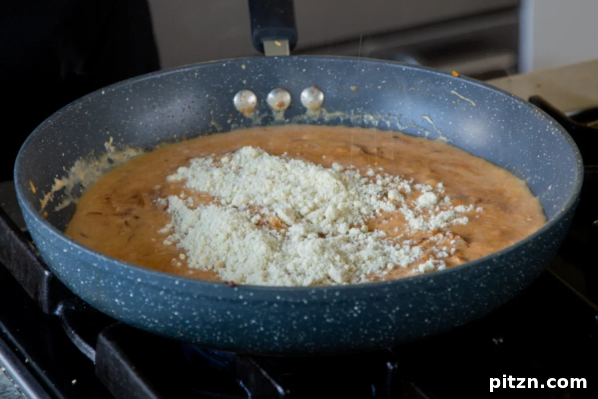 Sprinkling almond flour onto the sauce in the pan, a key ingredient for thickening and texture.