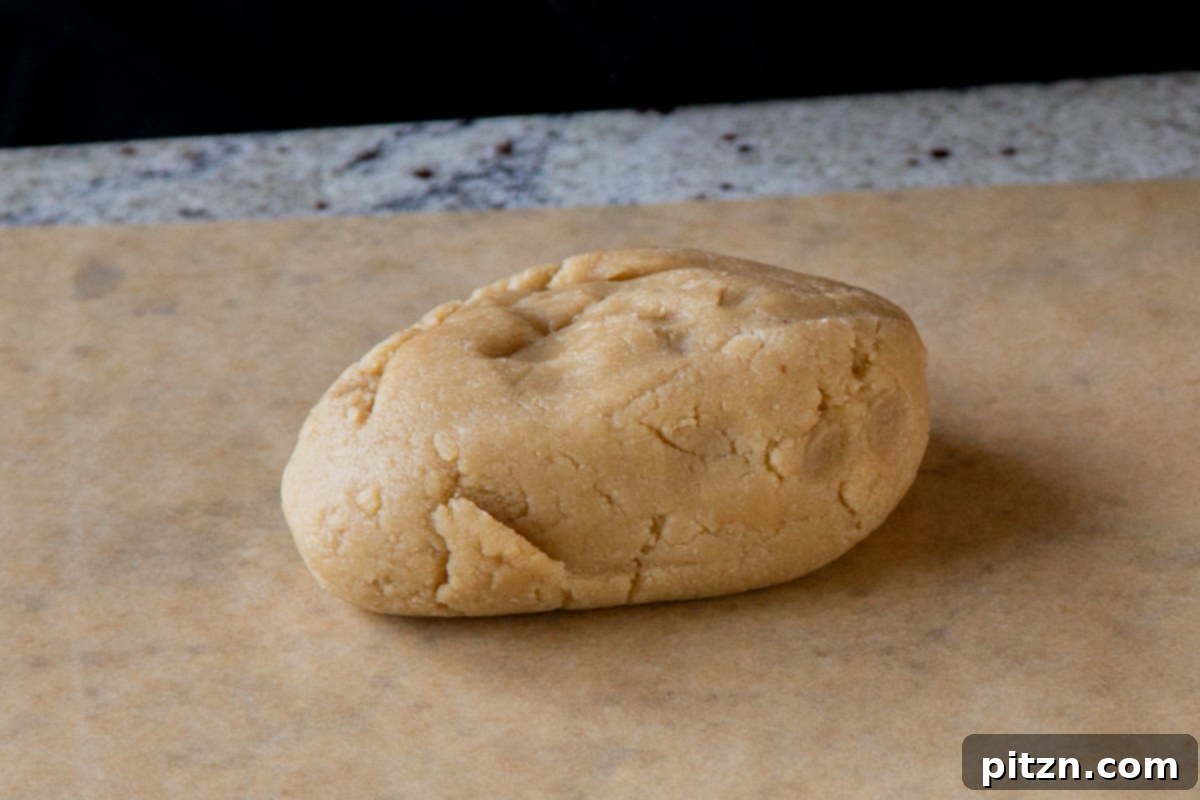 almond flour cookie dough on a parchment sheet, rolled out perfectly