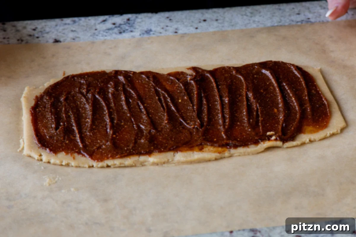 pumpkin pie spice mixture all spread out on the almond flour cookie dough, showing full coverage