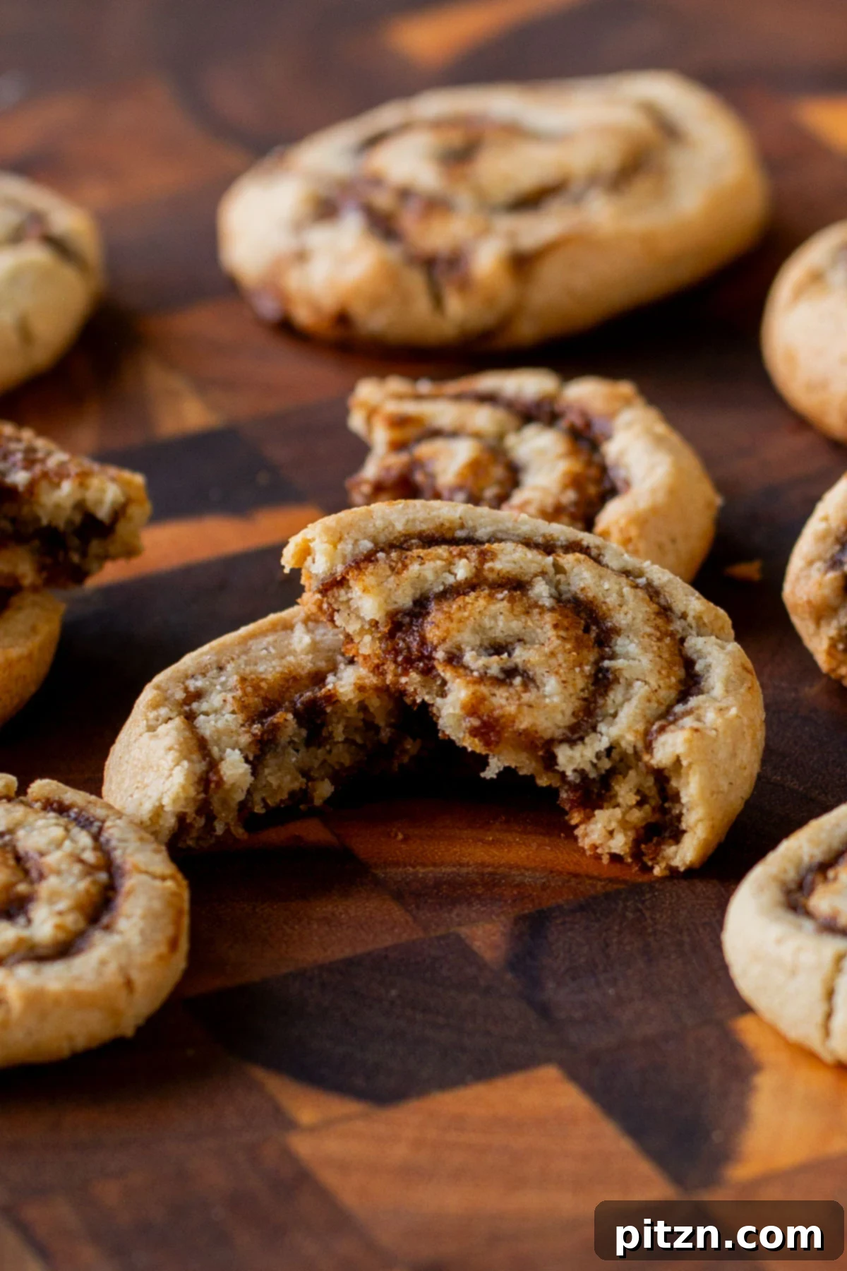 close-up of a pumpkin spice roll cookie broken in half, so you can see the texture