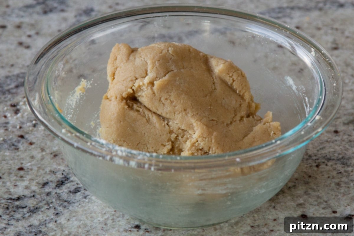 almond flour cookie dough in the mixing bowl, showing the perfect consistency for rolling