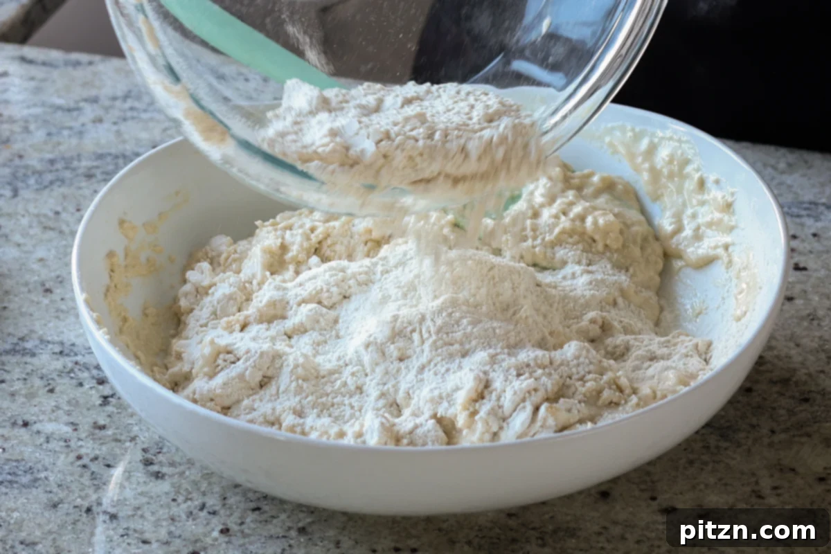 Melt-in-Your-Mouth Dinner Rolls 13 adding more flour to the mixture