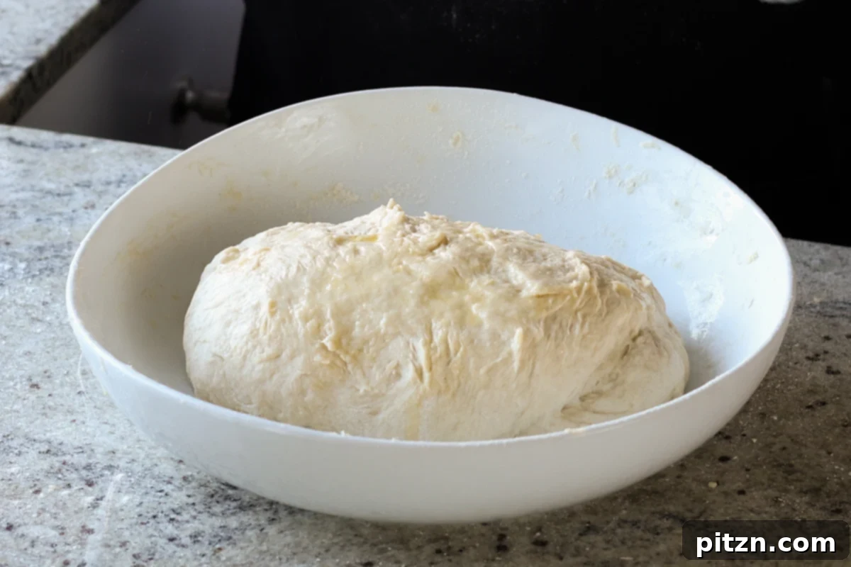 Melt-in-Your-Mouth Dinner Rolls 16 dough in the bowl, ready to rise