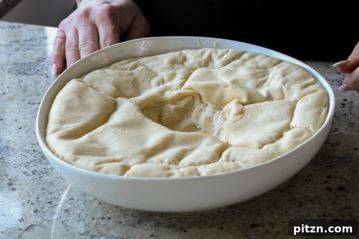 Melt-in-Your-Mouth Dinner Rolls 19 dough in the bowl after rising and punching down
