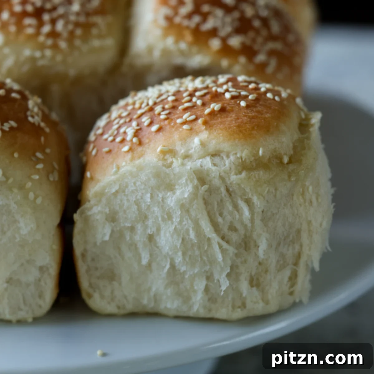 Melt-in-Your-Mouth Dinner Rolls 27 fluffy dinner rolls on a serving tray after pulling apart