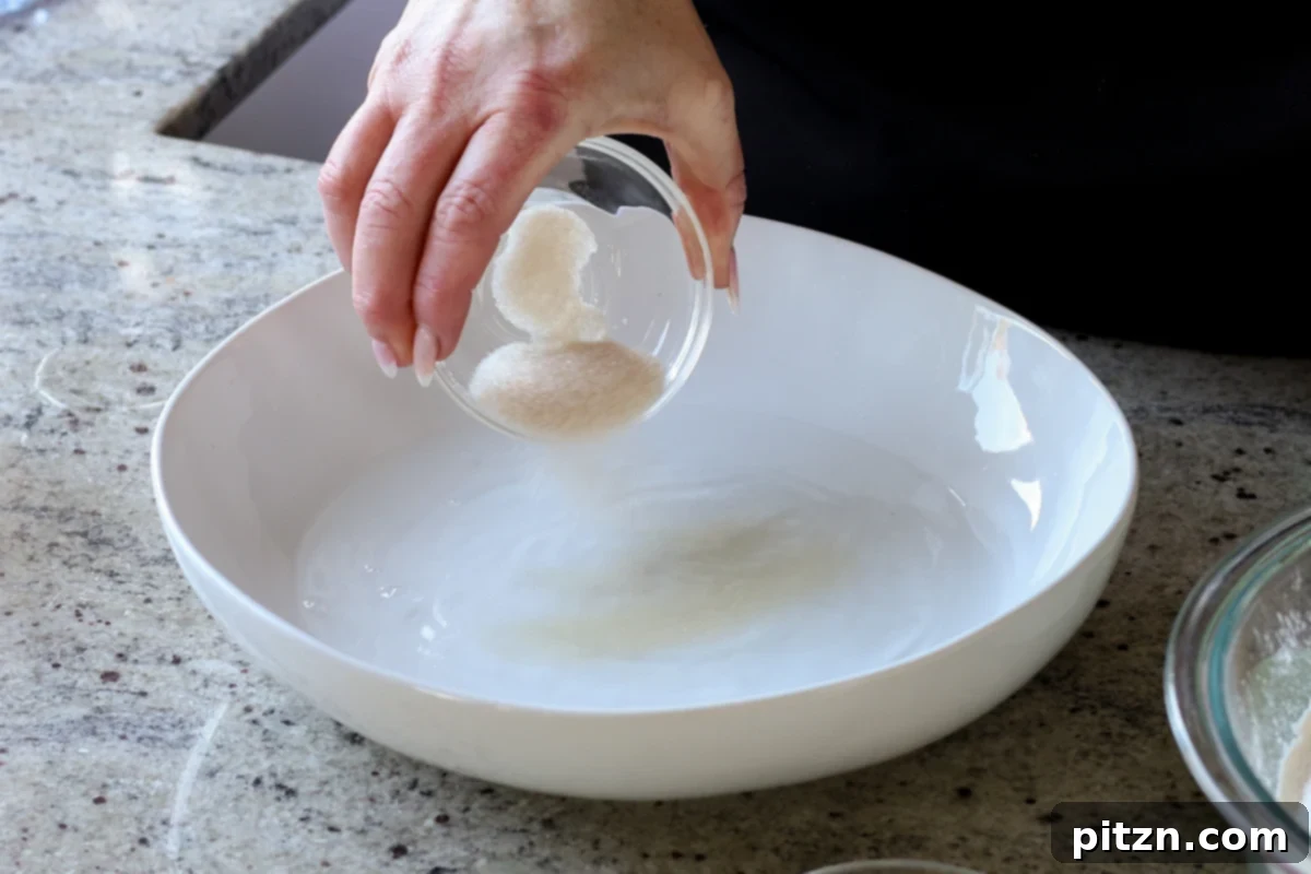 Melt-in-Your-Mouth Dinner Rolls 7 adding sugar and yeast to the water