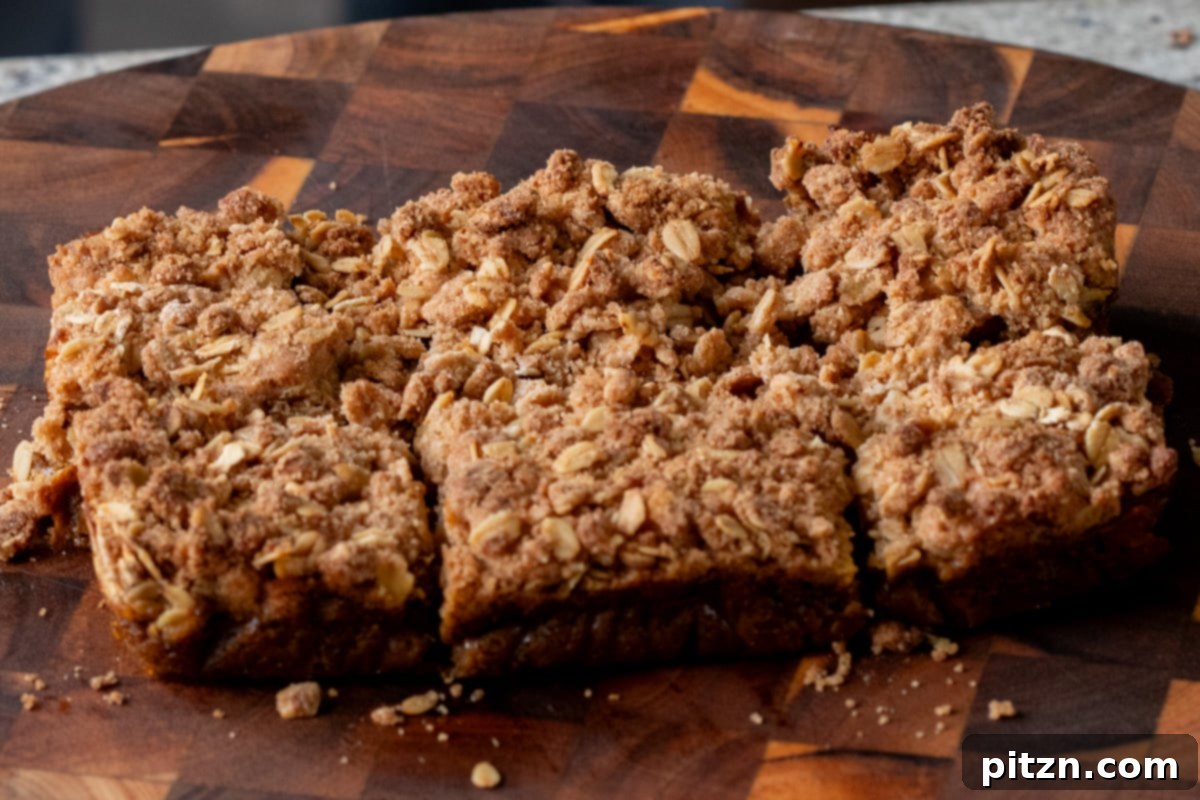 sliced pumpkin crisp on the cutting board, after removing from the baking pan