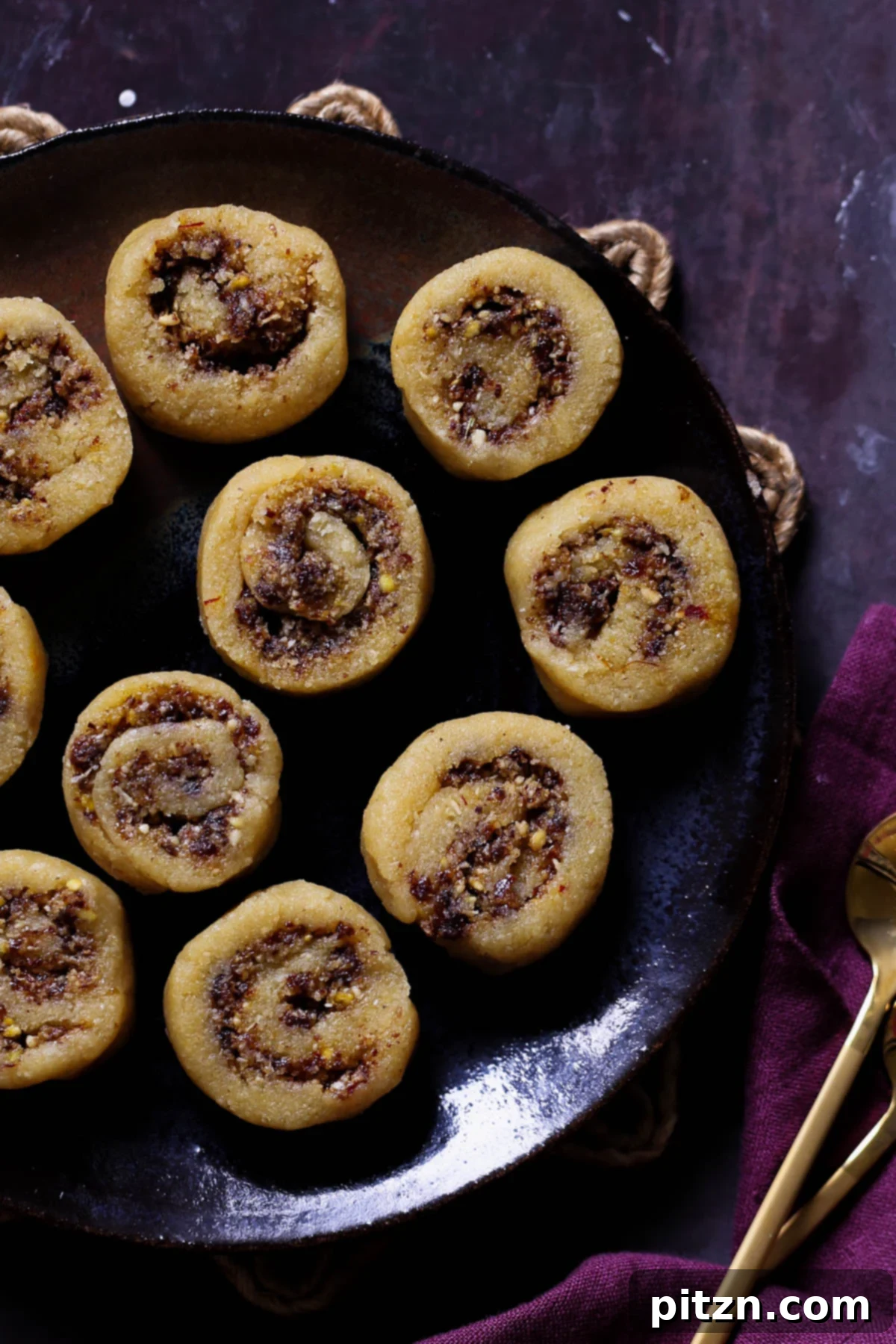 Beautifully arranged Gujiya Peda on a dark brown plate, showcasing its exquisite layers and inviting texture.