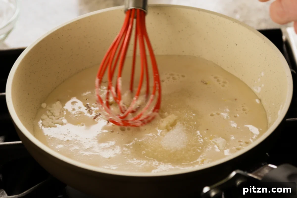 The custard ingredients being thoroughly mixed in the saucepan before heating, ensuring a smooth consistency.