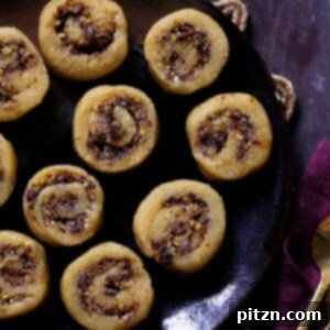 gujiya peda on a dark brown plate
