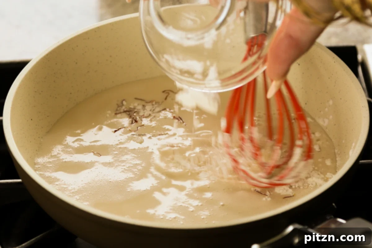 Adding oat milk, saffron, sugar, and corn starch to a saucepan to prepare the custard for Gujiya Peda.