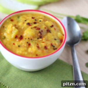 Pigeon pea soup in a white bowl on a green tablecloth