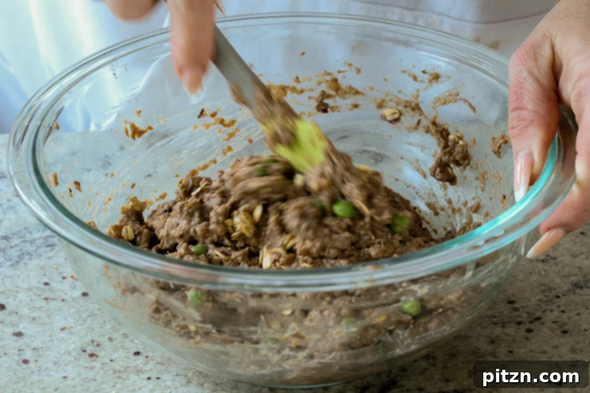 Ultimate Gluten-Free Vegan Wellington 17 Mixing the whole ingredients, including lentils, oats, and vegetables, into the processed lentil mixture until just combined.