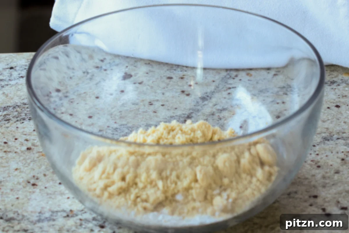 Ultimate Gluten-Free Vegan Wellington 19 Almond flour, spices, and tapioca starch in a bowl, ready to be mixed for the gluten-free Wellington crust.