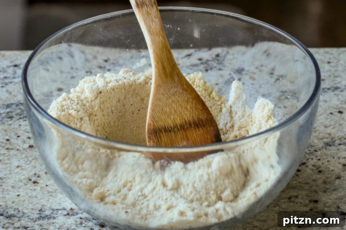 Ultimate Gluten-Free Vegan Wellington 20 Dry ingredients for the gluten-free crust, including almond flour and tapioca starch, thoroughly mixed in a bowl.
