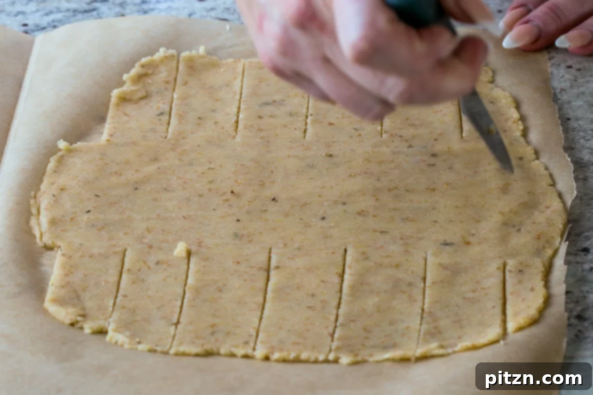 Ultimate Gluten-Free Vegan Wellington 26 Slicing the sides of the rolled-out dough into ribbons, preparing to wrap the lentil loaf for a decorative Wellington.