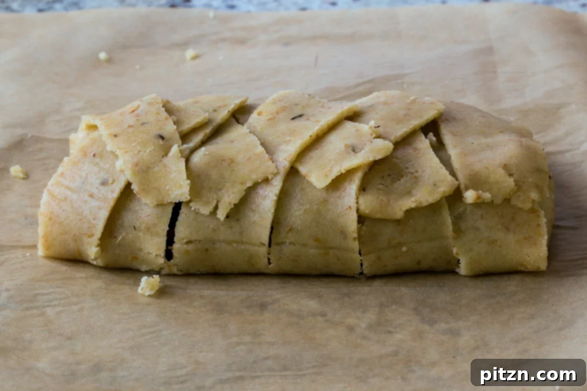 Ultimate Gluten-Free Vegan Wellington 30 A fully wrapped Gluten-Free Vegan Wellington, adorned with decorative pastry cutouts, and ready for baking.