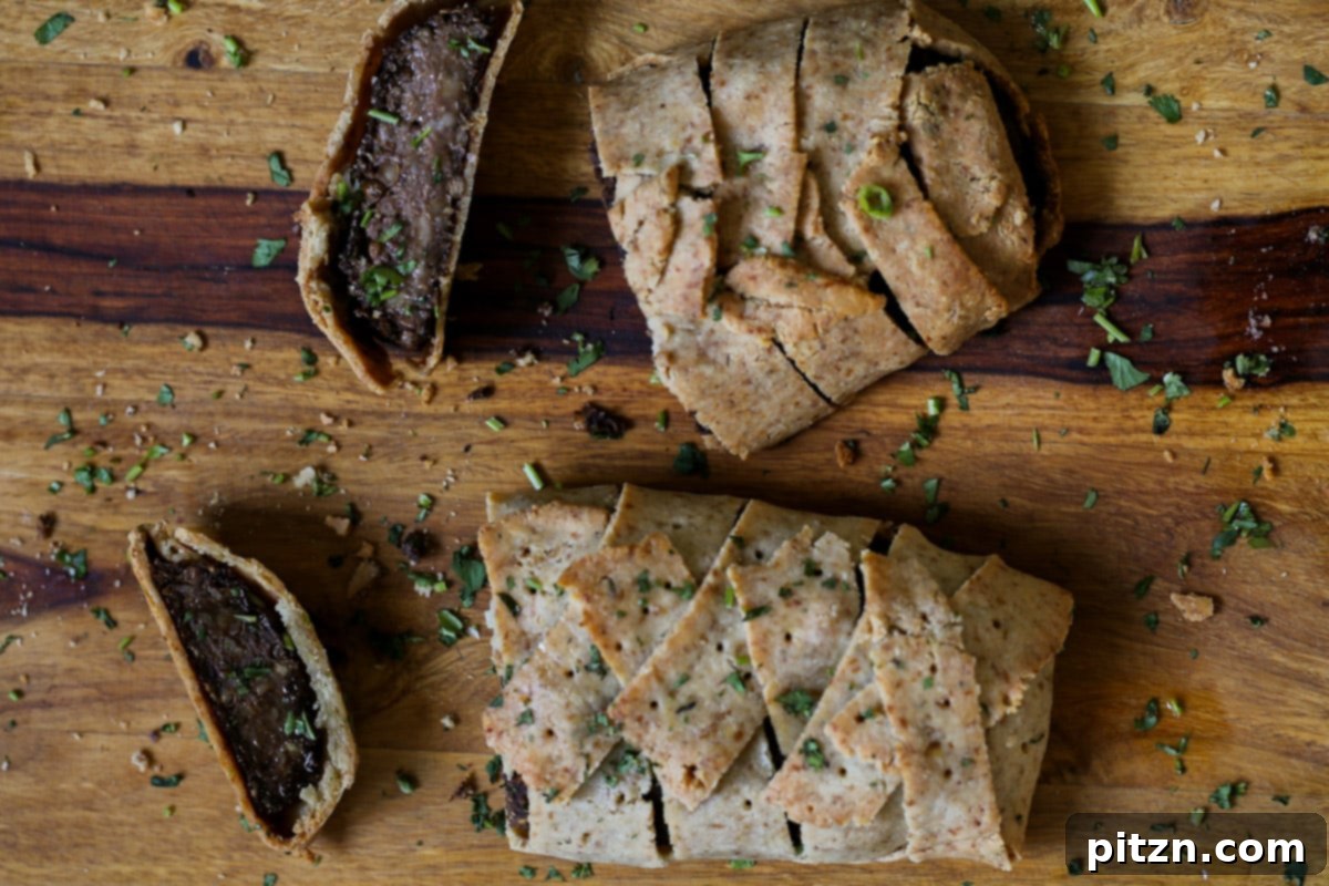Ultimate Gluten-Free Vegan Wellington 32 A close-up view of a beautifully sliced Gluten-Free Vegan Wellington on a cutting board, showcasing its tender filling and perfectly baked crust.