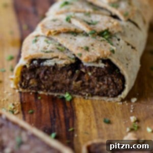 Gluten-Free Vegan Wellington on a cutting board after baking and slicing, a perfect festive main dish.