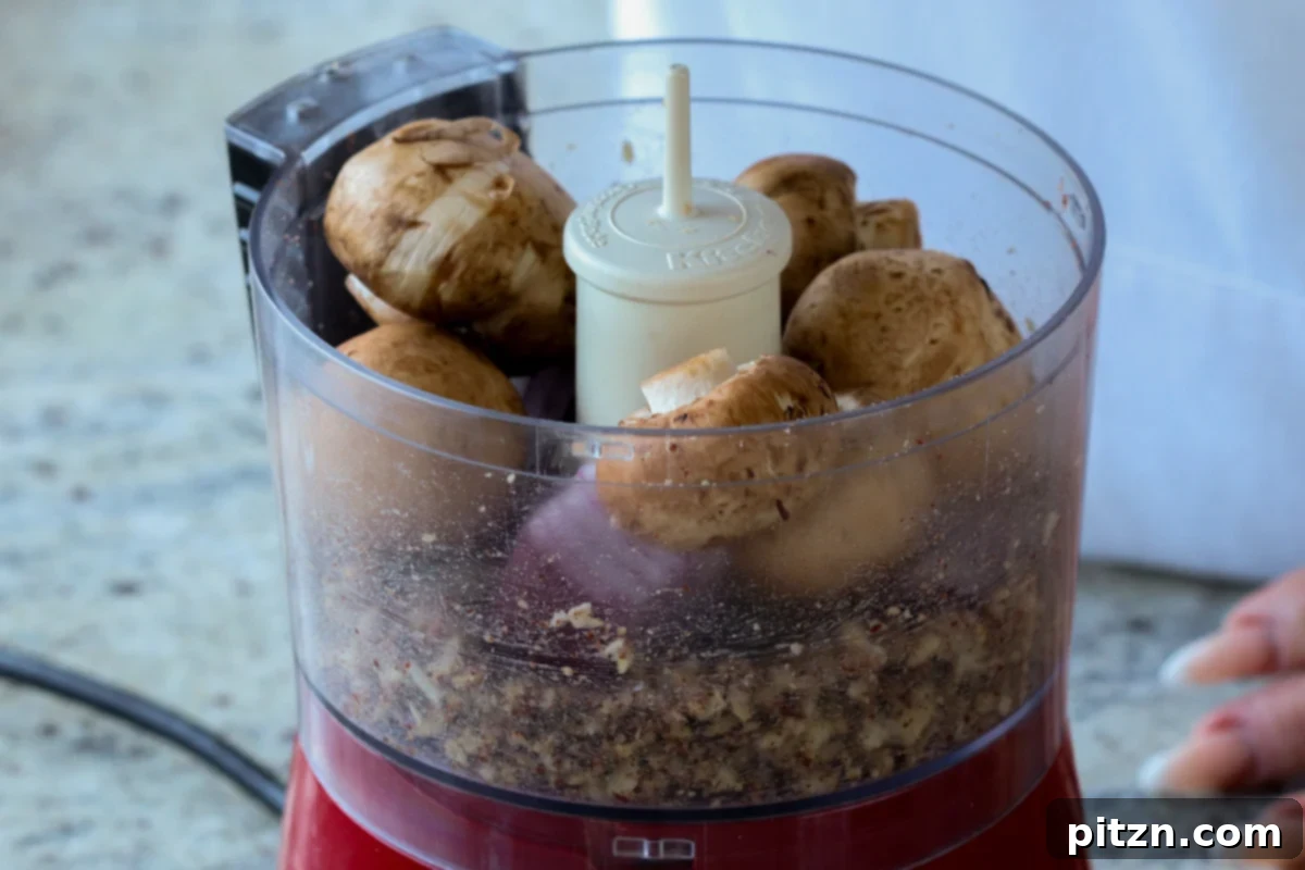 Ultimate Gluten-Free Vegan Wellington 9 Adding mushrooms and a portion of the lentils to the food processor with the pulsed pecan, onion, and garlic mixture.