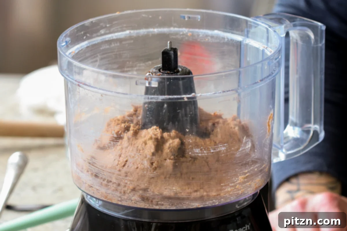 The chickpea mixture after all ingredients have been processed in the food processor, showing a well-combined yet still textured consistency.