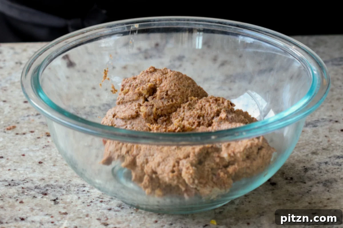 The processed chickpea mixture has been transferred to a large mixing bowl, ready for the final additions and shaping.