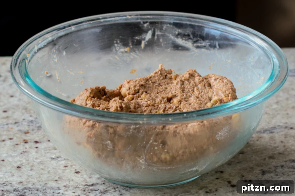 The fully mixed chickpea loaf dough in a bowl, showcasing its readiness for shaping and baking.