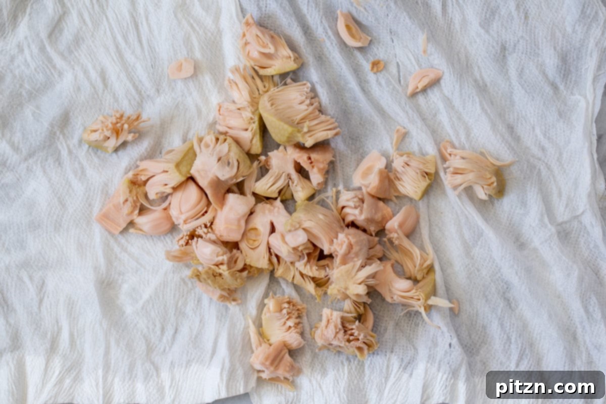 Drained jackfruit, pressed and wrung out with towels, ready for seasoning.