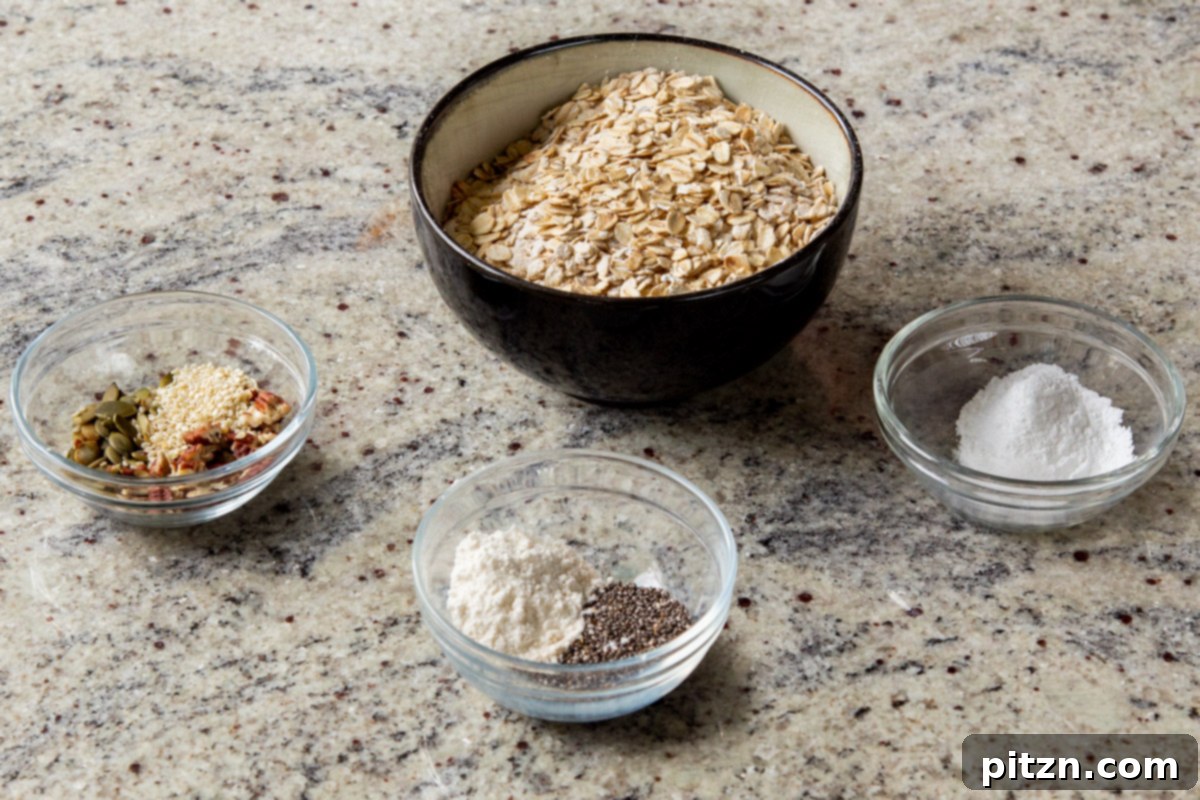 Cozy Baked Oatmeal Gift Mix 7 A selection of dry ingredients for baked oatmeal mix laid out in separate bowls: oats, flour, and various spices on a kitchen counter.