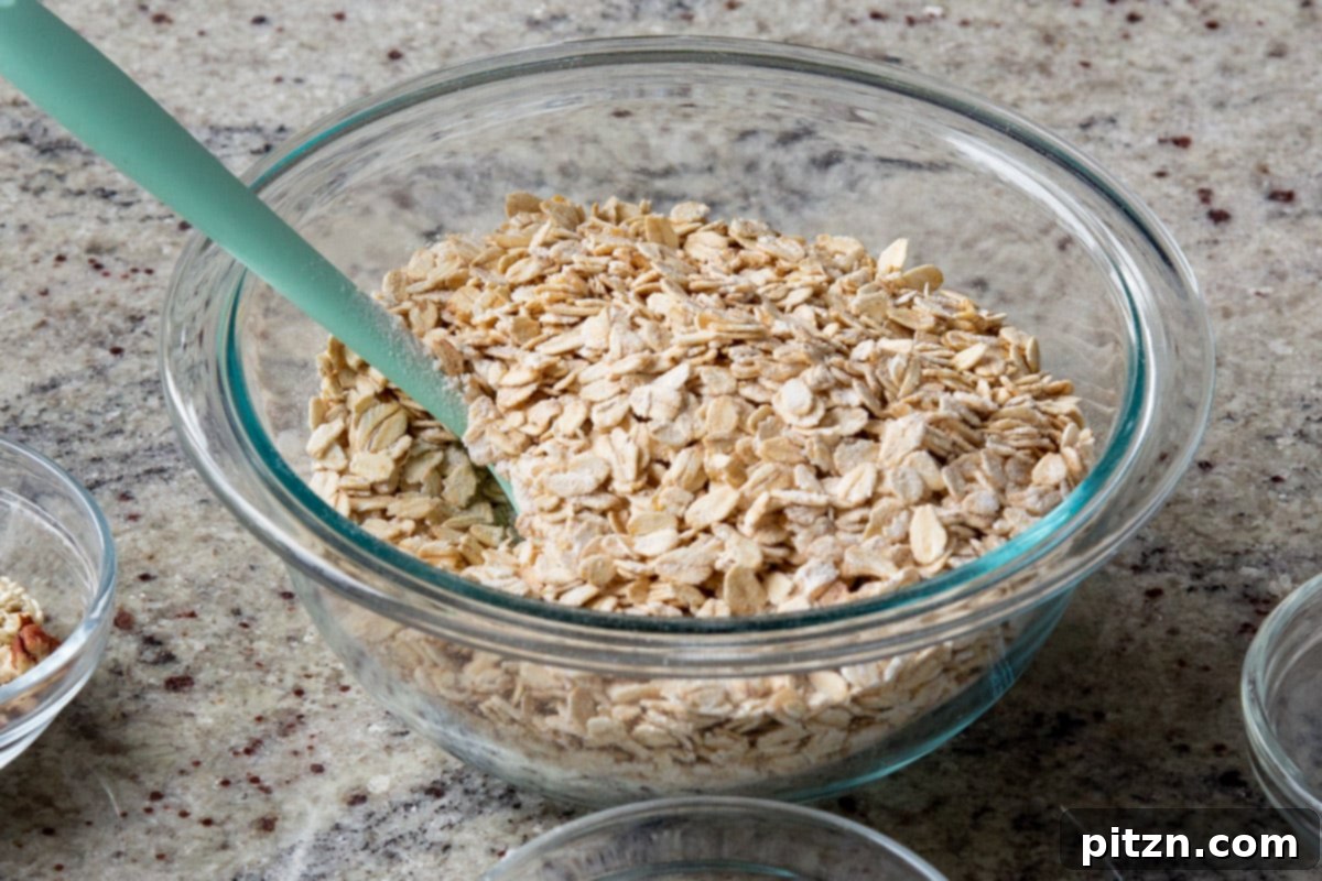 Cozy Baked Oatmeal Gift Mix 8 Dry rolled oats in a large mixing bowl, ready for other ingredients to be added.