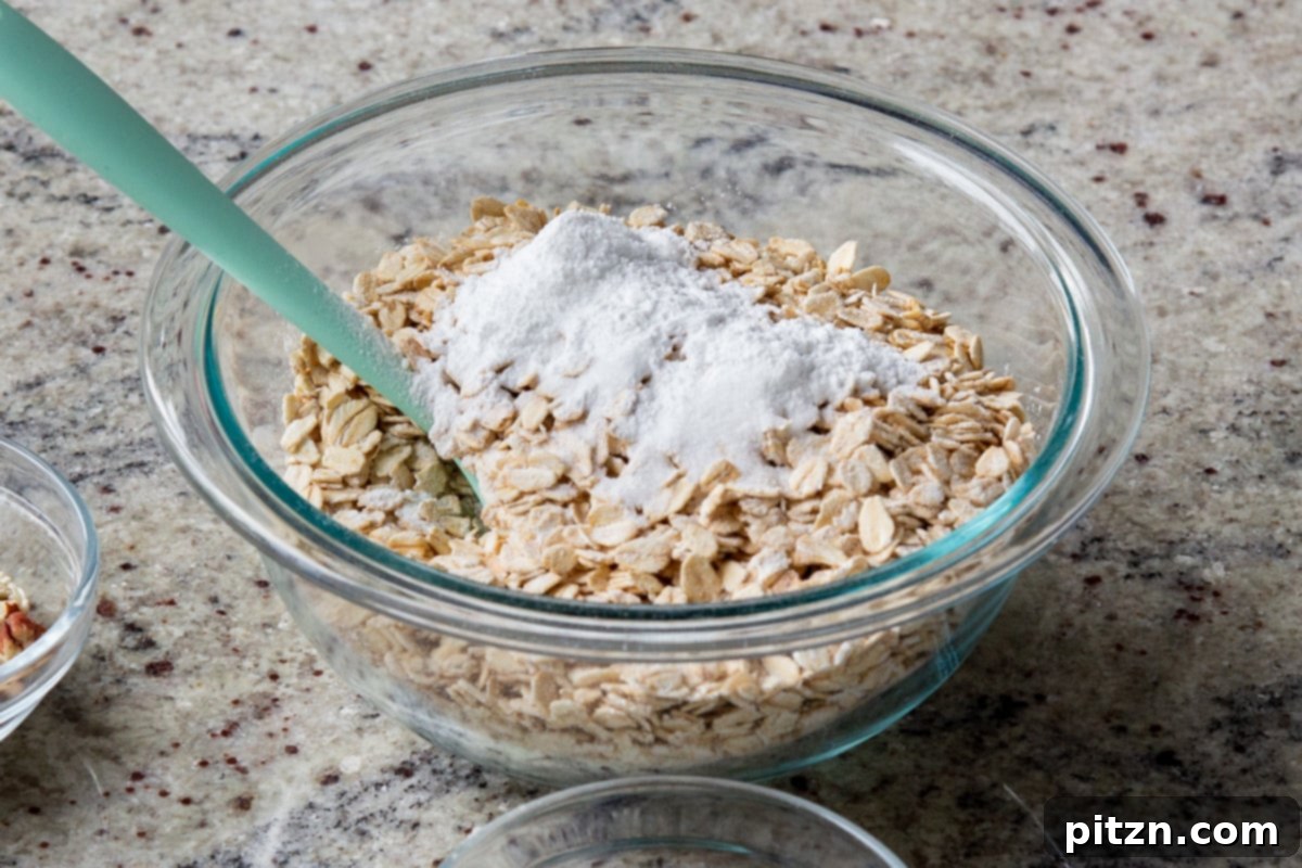 Cozy Baked Oatmeal Gift Mix 9 Baking powder and salt being added to the bowl of oats, two essential leavening and seasoning agents for baked oatmeal.